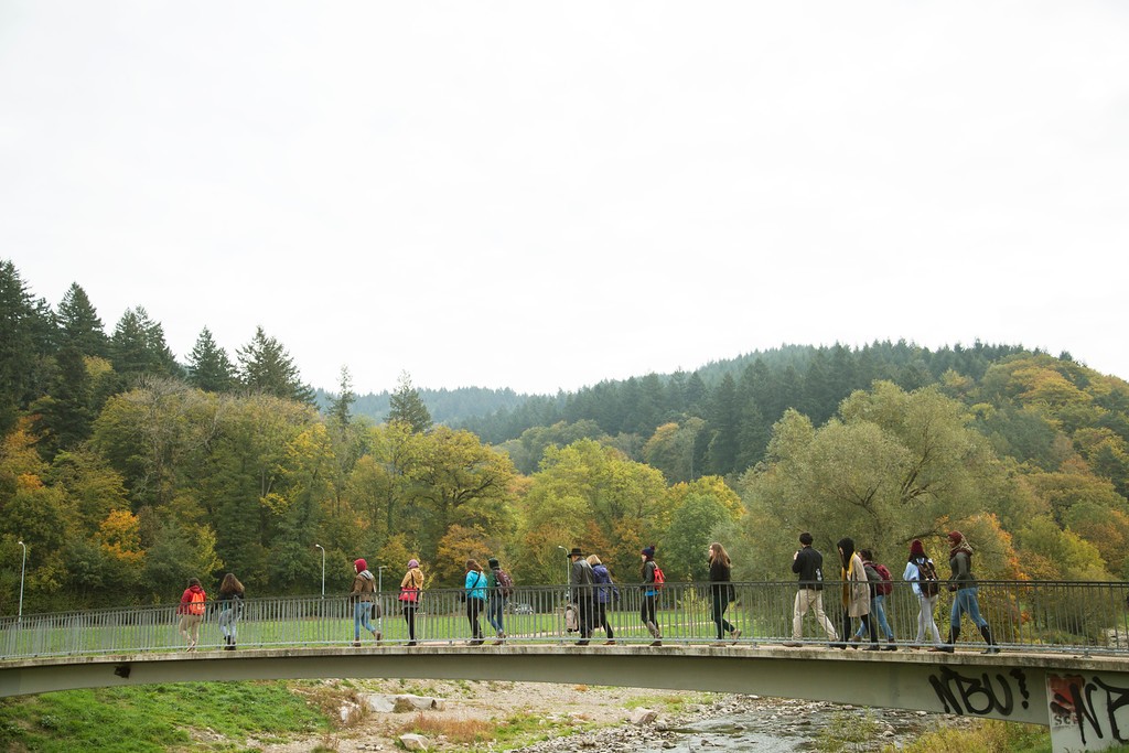 Students cross the Dreisam River